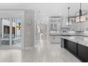 Open-concept kitchen with pendant lighting, island with marble countertop, and stainless steel appliances at 100 Serenity Point Dr., Little River, SC 29566