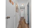 Hallway with wood floors, neutral walls, and doors leading to various rooms at 1095 Plantation Dr. W # 29 N, Little River, SC 29566
