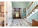 Entryway showcasing the decorative glass front door, staircase, and patterned rug on hardwood floors at 124 Windmeadows Dr., Conway, SC 29526