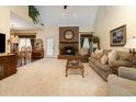 Spacious living room featuring a brick fireplace, plush carpeting, and vaulted ceilings at 124 Windmeadows Dr., Conway, SC 29526