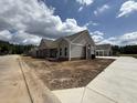 Street view of newly constructed homes boasting sidewalks, landscaping, and craftsman-style architecture at 135 Stonewall Circle # 7-2, Longs, SC 29568
