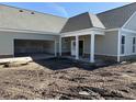 New construction home with an open garage and a covered front porch, featuring a neutral color palette at 135 Stonewall Circle # 7-2, Longs, SC 29568