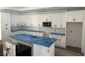 Bright, contemporary kitchen with white cabinets, stainless steel microwave and island at 135 Stonewall Circle # 7-2, Longs, SC 29568