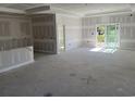 Spacious living room with a sliding glass door and fresh drywall ready for custom finishes at 135 Stonewall Circle # 7-2, Longs, SC 29568