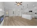 Spacious living room featuring wood floors, ceiling fan, and fireplace at 135 Stonewall Circle # 7-2, Longs, SC 29568