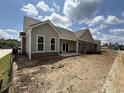 Back of house showing covered patio and neutral color scheme at 135 Stonewall Circle # 7-2, Longs, SC 29568