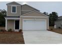 Two-story home with an attached garage and a concrete driveway at 135 Warner Crossing Way, Loris, SC 29569