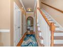 Inviting foyer with hardwood floors, staircase, and arched doorway leading to the living area at 1631 Low Country Pl. # E, Myrtle Beach, SC 29577