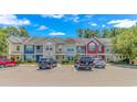A row of townhomes featuring colorful exteriors and ample parking on a sunny day at 1631 Low Country Pl. # E, Myrtle Beach, SC 29577