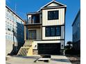 New construction with a staircase leading to the front door and a black garage door at 168 West Palms Dr., Myrtle Beach, SC 29579