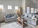Cozy living room with modern sofas, neutral decor, and bright natural light at 1856 Melville Ct., Little River, SC 29566