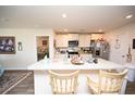 Bright kitchen featuring a large island with seating, modern appliances, and access to other rooms at 203 Golden Bear Circle, Longs, SC 29568