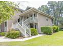Charming condo featuring a front porch, white railings, and well-manicured bushes at 227 Pinehurst Ln. # 6D, Pawleys Island, SC 29585
