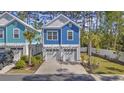 Charming blue two-story home with white trim, garage and neatly landscaped yard at 2409 Seabreeze Pl., Myrtle Beach, SC 29577