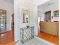 Welcoming foyer featuring tile flooring, decorative wallpaper, and arched doorways into the living spaces at 321 Heather Ct., Sunset Beach, NC 28468