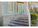 Inviting front entrance with brick steps, decorative door, and a well-maintained exterior at 321 Heather Ct., Sunset Beach, NC 28468