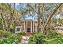 Brick home featuring a grand entrance with columns and well-maintained landscaping and walkway at 356 Chapman Loop, Pawleys Island, SC 29585