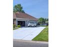 Spacious driveway leading to a two-car garage, with a view of the pond at 388 Carriage Lake Dr., Little River, SC 29566