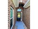Welcoming entryway with brick accents and a view of the front yard at 388 Carriage Lake Dr., Little River, SC 29566