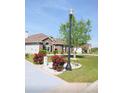 Beautiful front yard with roses, a street lamp, and well-kept landscaping at 388 Carriage Lake Dr., Little River, SC 29566
