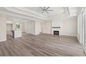 Spacious living room featuring tray ceiling, fireplace, hardwood floors, and an abundance of natural light at 4022 Macks Rd, Aynor, SC 29511