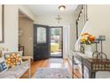 Bright foyer with hardwood floors, decorative rug, and a clear view to the front yard through the glass door at 403 Brandymill Blvd, Myrtle Beach, SC 29588