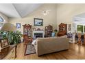 Inviting living room with hardwood floors, fireplace, high ceilings, and large windows for abundant natural light at 414 Staghorn Ln., Longs, SC 29568