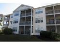 Exterior of a condo with screened-in patios and green lawn at 5020 Windsor Green Way # 302, Myrtle Beach, SC 29579
