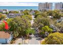 An aerial view shows proximity to the ocean with mature trees lining a quiet street at 504 A S 19Th Ave. S, North Myrtle Beach, SC 29582