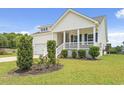 Exterior view of a charming home, showing well-manicured landscaping and a side porch at 512 Charlton Blvd., Georgetown, SC 29440