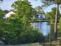 Scenic view of the neighborhood pond, surrounded by lush greenery and mature trees at 512 Charlton Blvd., Georgetown, SC 29440