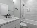 Elegant bathroom with a marble-style tiled wall, bathtub, and contemporary fixtures at 6001 S Kings Hwy., Myrtle Beach, SC 29575