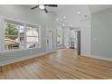 Bright living room with hardwood floors and abundant natural light from large windows at 6001 S Kings Hwy., Myrtle Beach, SC 29575