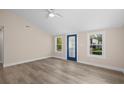 Bright living room features neutral walls, modern ceiling fan, and durable wood-look flooring at 617 Sparrow Dr., Surfside Beach, SC 29575