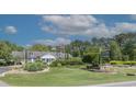 Beautiful community clubhouse surrounded by lush landscaping, with American flags waving in the breeze at 6486 Somersby Dr., Murrells Inlet, SC 29576