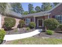 Inviting front entrance with a well-maintained walkway, a covered porch, and manicured landscaping at 6486 Somersby Dr., Murrells Inlet, SC 29576