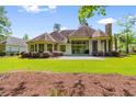 The back of the home has a large patio area and lush green lawn, perfect for outdoor entertaining at 8008 Mcsweeney Ct., Myrtle Beach, SC 29588