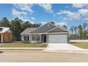 Charming single-story home with gray siding, stone accents, and a spacious two-car garage at 108 Old Chimney Ln, Conway, SC 29526
