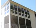 Close up of a sunroom featuring a wall of windows and a screened in porch at 1533 Lanterns Rest Rd. # 304, Myrtle Beach, SC 29579