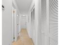 Bright hallway features tile flooring and leads to a white door at the end at 1851 Colony Dr. # 4-F, Surfside Beach, SC 29575