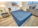 Calm bedroom with a blue quilted bedspread, dresser, and serene decor elements at 2310 N Ocean Blvd. # 308, Myrtle Beach, SC 29572