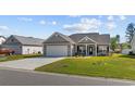 Charming single-story home with a well-manicured lawn and inviting front entrance at 237 Copperwood Loop, Conway, SC 29526