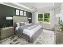 Tranquil main bedroom with dark gray accent wall, stylish decor, lots of natural light, and ample closet space at 2508 Watershed Way, Longs, SC 29568