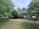 Side view of a brick home showcasing a well-manicured yard and mature landscaping at 2560 Wise Rd., Conway, SC 29526