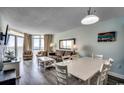 Cozy living and dining area with comfortable seating, natural light, and an ocean view through the balcony doors at 2711 S Ocean Blvd. # 1917, North Myrtle Beach, SC 29582