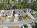 An aerial view showcases the home's location within a quiet, tree-lined neighborhood at 3053 Chesterwood Ct., Myrtle Beach, SC 29579
