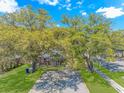 Home with a large front yard and mature trees, showcasing curb appeal at 311 Surfside Dr., Surfside Beach, SC 29575