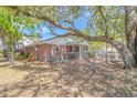 View of a backyard with a brick home, a small patio, and chain link fence at 311 Surfside Dr., Surfside Beach, SC 29575