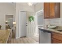 Inviting entryway featuring neutral tones, decorative wreath on door, and granite countertops in the kitchen at 4411 Grande Harbour Blvd., Little River, SC 29566