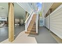 Exterior wooden stairway, enclosed outdoor shower, and sturdy support beams for a coastal home at 4411 Grande Harbour Blvd., Little River, SC 29566